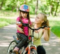 Beautiful mother calms the sad daughter who did not get to ride