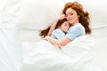 beautiful mother and daughter hugging and sleeping together Royalty Free Stock Photo