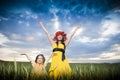 Beautiful mother and daughter in the wheat field