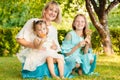 Beautiful mother with daughters outdoors in summer in the park Royalty Free Stock Photo