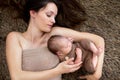 Beautiful mother embracing with tenderness and care her newborn son, shot from above Royalty Free Stock Photo