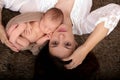 Beautiful mother embracing with tenderness and care her newborn son, shot from above Royalty Free Stock Photo