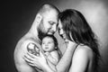 Beautiful mother and father smiling holding their newborn baby girl. Royalty Free Stock Photo