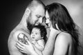 Beautiful mother and father smiling holding their newborn baby girl. Royalty Free Stock Photo