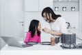 Beautiful mother feed daughter in the kitchen