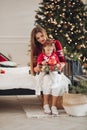 Beautiful mother giving her daughter a present.