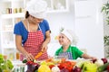 Beautiful mother with happy adorable son prepare food for dinner Royalty Free Stock Photo