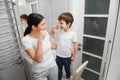 Beautiful mother and happy son brushing teeth near mirror in bathroom Royalty Free Stock Photo