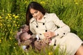 Beautiful mother having fun with her little cute baby in summer garden