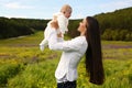 Beautiful mother having fun with her little cute baby in summer garden Royalty Free Stock Photo