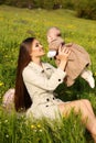 Beautiful mother having fun with her little cute baby in summer garden Royalty Free Stock Photo