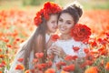 Beautiful mother and her daughter playing in spring flower field Royalty Free Stock Photo