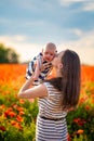 Beautiful mother and her daughter in spring poppy flower field, Czech republic Royalty Free Stock Photo