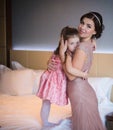 Beautiful mother hugs daughter in the bedroom Royalty Free Stock Photo