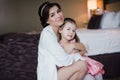 Beautiful mother hugs daughter in the bedroom Royalty Free Stock Photo