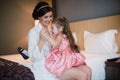 Beautiful mother hugs daughter in the bedroom Royalty Free Stock Photo