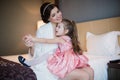 Beautiful mother hugs daughter in the bedroom Royalty Free Stock Photo