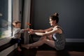 Beautiful Mother hugs son, kisses tenderly and holds gerbera flower in hand. Authentic portrait of real family, sunny