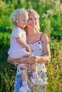 Beautiful mother with infant curly-headed daughter