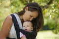 Beautiful mother kissing cute baby on the head Royalty Free Stock Photo