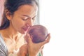 Beautiful mother kissing here little cute baby on her palm. Royalty Free Stock Photo