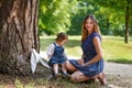 Beautiful mother and little daughter walking in summer park Royalty Free Stock Photo