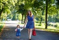 Beautiful mother and little daughter walking in summer park Royalty Free Stock Photo