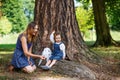 Beautiful mother and little daughter walking in summer park Royalty Free Stock Photo