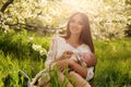 Beautiful mother posing with her little cute baby in blossom garden Royalty Free Stock Photo