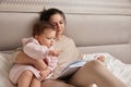 beautiful mother reading book to her cute little baby daughter Royalty Free Stock Photo