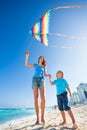 Beautiful mother and son holding arms with kite Royalty Free Stock Photo