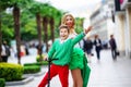 Beautiful mother and son spend active time and ride a scooter together