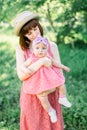 Beautiful Mother with the straw hat And her little daughter outdoors family look in in a pink dress . Outdoor Portrait Royalty Free Stock Photo