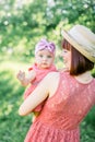 Beautiful Mother with the straw hat And her little daughter outdoors family look in in a pink dress . Outdoor Portrait Royalty Free Stock Photo