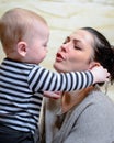 Beautiful mother talking to curious infant