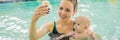 Beautiful mother teaching cute baby girl how to swim in a swimming pool. Child having fun in water with mom BANNER, LONG Royalty Free Stock Photo