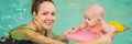 Beautiful mother teaching cute baby girl how to swim in a swimming pool. Child having fun in water with mom BANNER, LONG Royalty Free Stock Photo