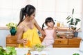 Beautiful mother with tight hair tied up wearing yellow dress, dress for pregnant women be comfortable, mother raises glass