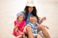 Beautiful mother and two kids enjoying beach vacation. Royalty Free Stock Photo