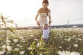 Beautiful mother is walking on field with little baby boy Royalty Free Stock Photo