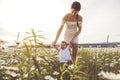 Beautiful mother is walking on field with little baby boy Royalty Free Stock Photo