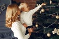 Mother with cute son at home near christmas tree Royalty Free Stock Photo