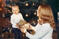 Mother with cute son at home near christmas tree Royalty Free Stock Photo