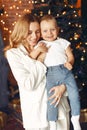 Mother with cute son at home near christmas tree Royalty Free Stock Photo