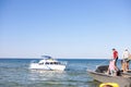 Beautiful motor boat in the Black sea clear blue water going to the shore near island in Skadovsk Region, Kherson Oblast near C