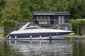 A beautiful motor cruiser cruising on the Thames at Henley-on-Thames in Oxfordshire