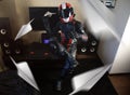 Beautiful motorcyclist in full gear and helmet launches paper airplane