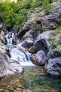 A beautiful mountain gorge with a river and a waterfall