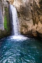 A beautiful mountain gorge with a river and a waterfall