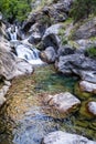 A beautiful mountain gorge with a river and a waterfall